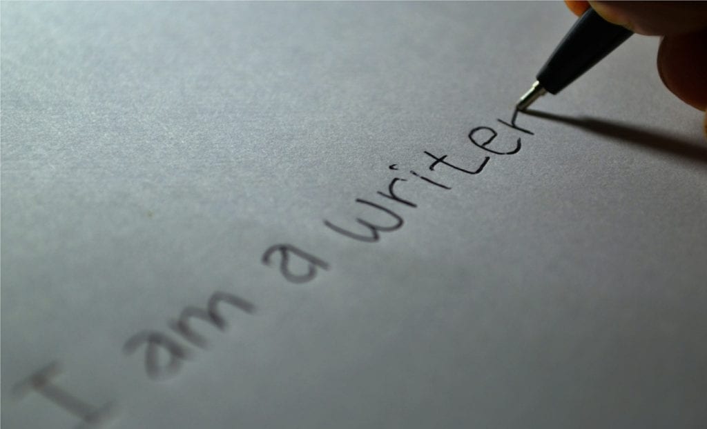 A handwritten sentence reading, "I am a writer"